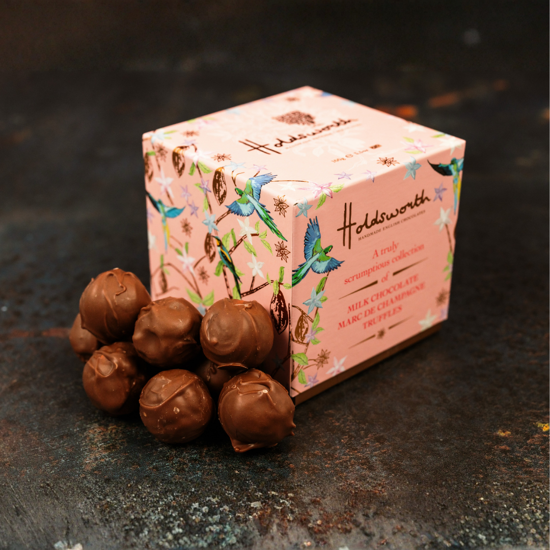 Holdsworth chocolate truffles with a decorative box on a dark surface